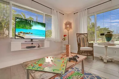 a living room with a flat screen tv on the wall at Casa Sol in Fort Lauderdale