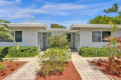 a white house with plants in front of it at Casa Sol in Fort Lauderdale