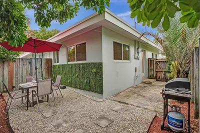 a house with a table and a grill in front of it at Casa Sol A in Fort Lauderdale