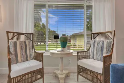 two chairs and a table in a room with a window at Casa Sol A in Fort Lauderdale