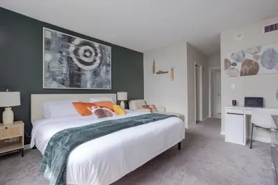 a bedroom with a large bed and a desk at 1-Bedroom Apartment with Ocean View and Balcony near Sunny Isles Beach in Sunny Isles Beach