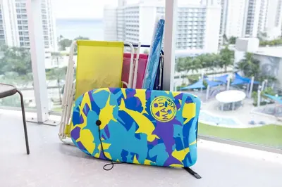 a colorful suitcase sitting on top of a balcony at 1-Bedroom Apartment with Ocean View and Balcony near Sunny Isles Beach in Sunny Isles Beach