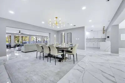 a dining room and kitchen with a table and chairs at Riverbend Yacht Retreat Waterfront Villa with Pool in Fort Lauderdale