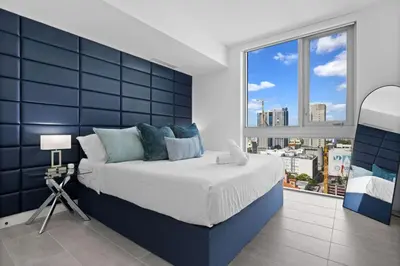 a bedroom with a large bed and a large window at CAL KING BED Downtown Miami Free Parking Pool Gym in Miami