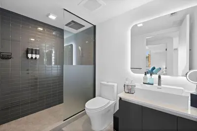 a bathroom with a toilet and a sink and a mirror at CAL KING BED Downtown Miami Free Parking Pool Gym in Miami