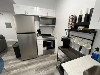 a kitchen with a stainless steel refrigerator and appliances at KING OF MIAMI - 2bd Retreat 1 mile from Brickell in Miami