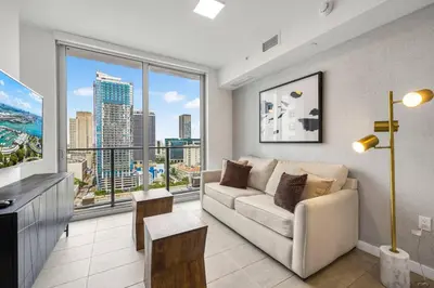 a living room with a couch and a large window at KING OF MIAMI - Downtown Free Parking Pool Gym in Miami