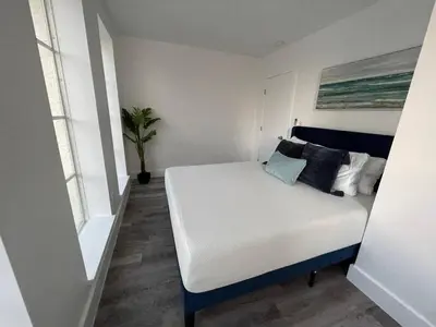 a bedroom with a white bed with pillows on it at KING OF MIAMI - 1 mile from Brickell 2BD Apartment! in Miami