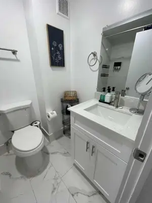 a bathroom with a toilet and a sink and a mirror at KING OF MIAMI - 1 mile from Brickell 2BD Apartment! in Miami