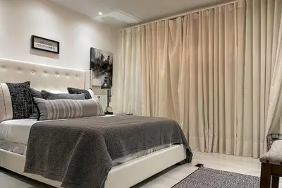 a bedroom with a large bed and curtains at Relax in the Sun! Gem 1 Mi to Las Olas Beach in Fort Lauderdale