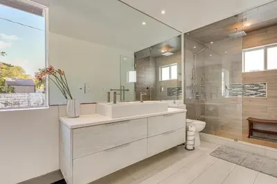a white bathroom with a sink and a toilet at Relax in the Sun! Gem 1 Mi to Las Olas Beach in Fort Lauderdale