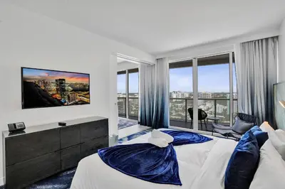 a bedroom with two beds and a flat screen tv at 2BR W Residence 18th Floor, Ocean, Inter-coastal, & City Views in Fort Lauderdale