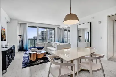 a living room with a table and a couch at 2BR W Residence 18th Floor, Ocean, Inter-coastal, & City Views in Fort Lauderdale