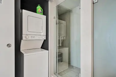 a small white refrigerator with a bottle on top of it at 2BR W Residence 18th Floor, Ocean, Inter-coastal, & City Views in Fort Lauderdale