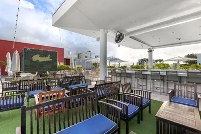 a group of chairs and tables on a patio at Luxury Condo with Serene Balcony View in Hollywood