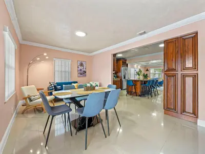 a dining room and living room with a table and chairs at Tropical Bay House-Near By Brickell, Wynwood and South Beach in Miami