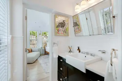 a white bathroom with a sink and a mirror at Garden Grove- Miami Home with Private Pool in Miami