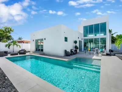 a swimming pool in front of a house at Villa Coral Bay in Miami Beach
