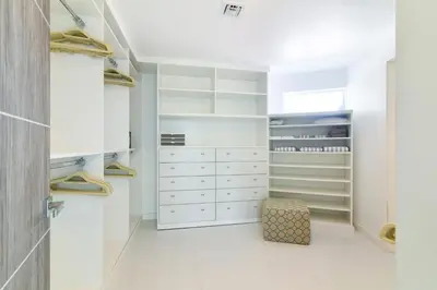 a white walk in closet with white cabinets at Villa Moonlight Haven in Miami Beach