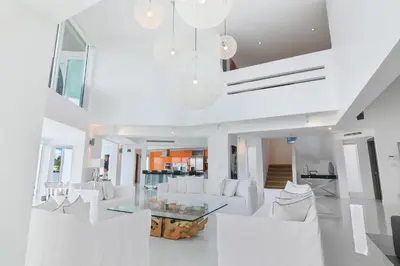a living room with white furniture and a glass table at Villa Moonlight Haven in Miami Beach