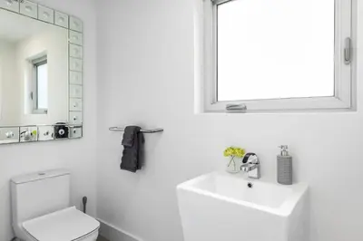 a white bathroom with a sink and a mirror at Villa Modern Miami glamour in Miami