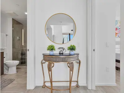 a bathroom with a vanity with a mirror on the wall at X Lounge VII-Private Sky Residence in Miami