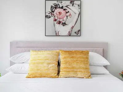 a bed with a yellow pillow on top of it at X Lounge VII-Private Sky Residence in Miami