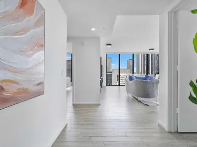 a living room with a couch and a painting on the wall at X Lounge VII-Private Sky Residence in Miami
