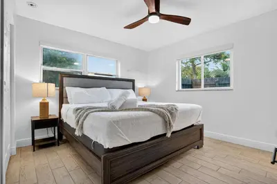 a bedroom with a bed and a ceiling fan at Heated Pool Home - Mini Golf & Soccer & Firepit in Hollywood