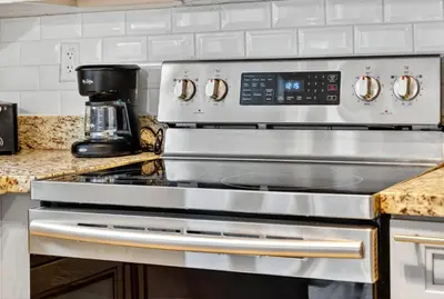 a stainless steel stove top oven in a kitchen at Heated Pool Home - Mini Golf & Soccer & Firepit in Hollywood