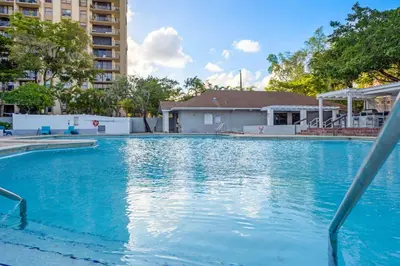 a swimming pool with blue water in a building at Centrally Located 2 BED in the Heart of NMB in North Miami