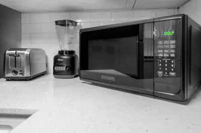 a kitchen counter with a microwave and a blender at Centrally Located 2 BED in the Heart of NMB in North Miami
