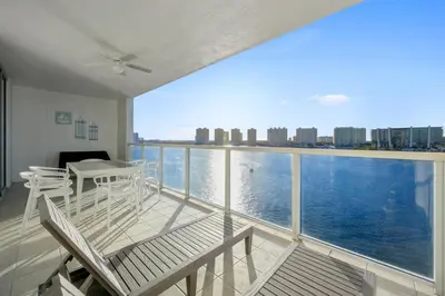 a balcony with a view of the water at Stylish, classy Bayfront view apt, Walk to beach in Sunny Isles Beach