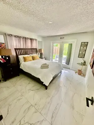 a bedroom with a large bed with a marble floor at Beach and Downtown Hollywood in Hollywood