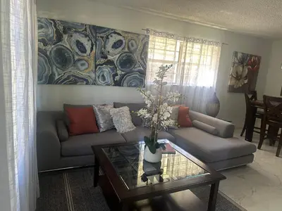 a living room with a couch and a glass table at Beach and Downtown Hollywood in Hollywood