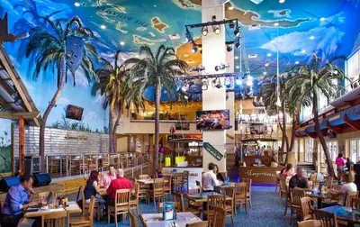 a restaurant with a mural of palm trees on the ceiling at Beach and Downtown Hollywood in Hollywood