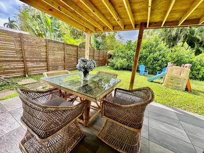 a patio with a glass table and wicker chairs at Beach and Downtown Hollywood in Hollywood