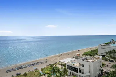 an aerial view of a beach and a building at Oceanfront corner unit in Hollywood