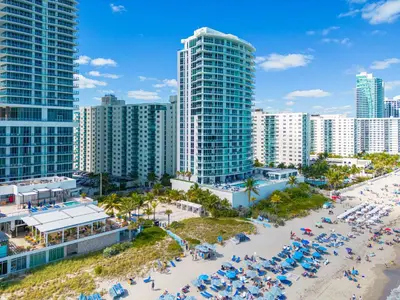 an aerial view of a beach in front of tall buildings at Oceanfront corner unit in Hollywood
