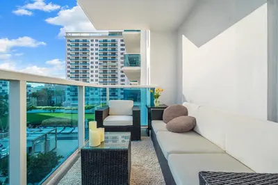 a living room with a couch and a view of a building at Roney Palace 408 in Miami Beach