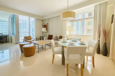 a dining room and living room with a table and chairs at AKA Hotel Stunning Views w- Free parking in Miami