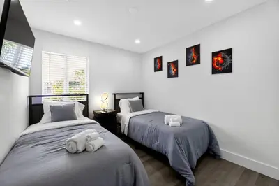 a bedroom with two beds with towels on them at 3-BDR Guitar House, Walk to Casino, located close to EVERYTHING! in Fort Lauderdale