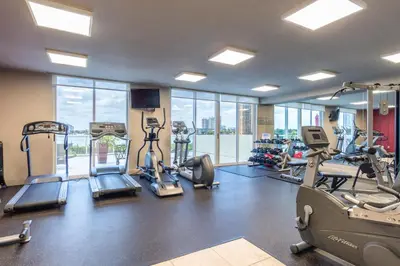 a gym with treadmills and cardio equipment in a building at Golden Bay 702 in Sunny Isles Beach