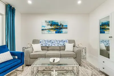 a living room with a couch and a table at 1 Mi to Las Olas Eats! Modern Apt with Shared Patio in Fort Lauderdale