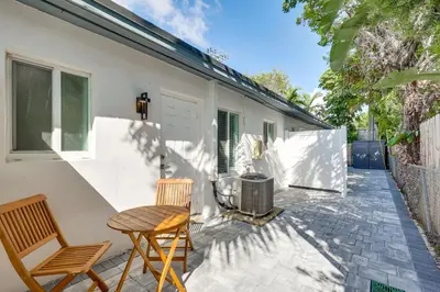 a patio with two chairs and a table at 1 Mi to Las Olas Eats! Modern Apt with Shared Patio in Fort Lauderdale