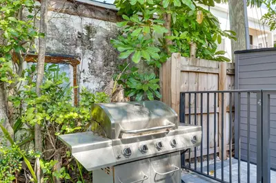 a stainless steel grill and stove in a garden at 1 Mi to Las Olas Eats! Modern Apt with Shared Patio in Fort Lauderdale