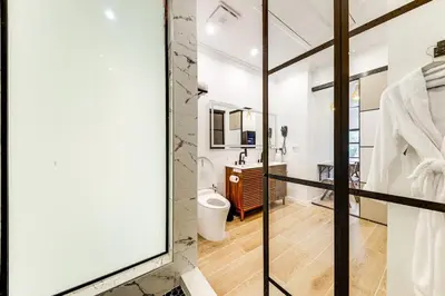 a bathroom with a toilet and a glass door at Home in Heart of Wilton Drive, 4 Mi to Beach in Fort Lauderdale