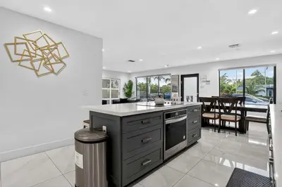 a kitchen with a counter and a dining room at Miami Private Pool Home 15 min to Beach - Aventura in Miami