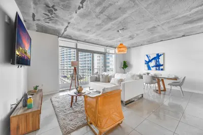 a living room with a couch and a table at Contemporary Midtown Condo - Pool & Free Parking in Miami