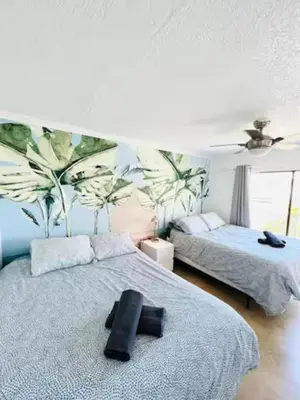 a bedroom with two beds and a large mural at The Blue Breeze - Parking included in Miami Beach